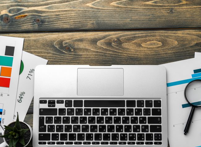 Financial report and laptop on business desk