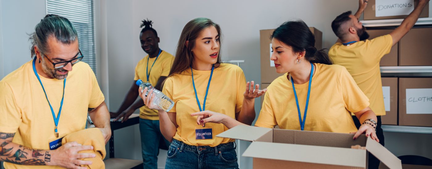Group of multiracial volunteers working in community charity donation center