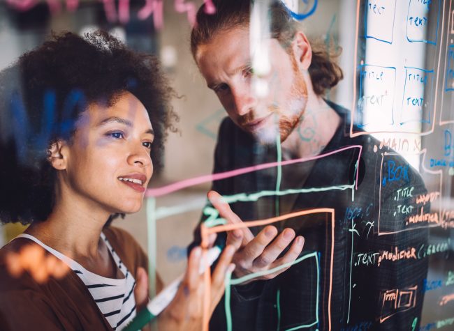 Programmers cooperating brainstorming at information technology company